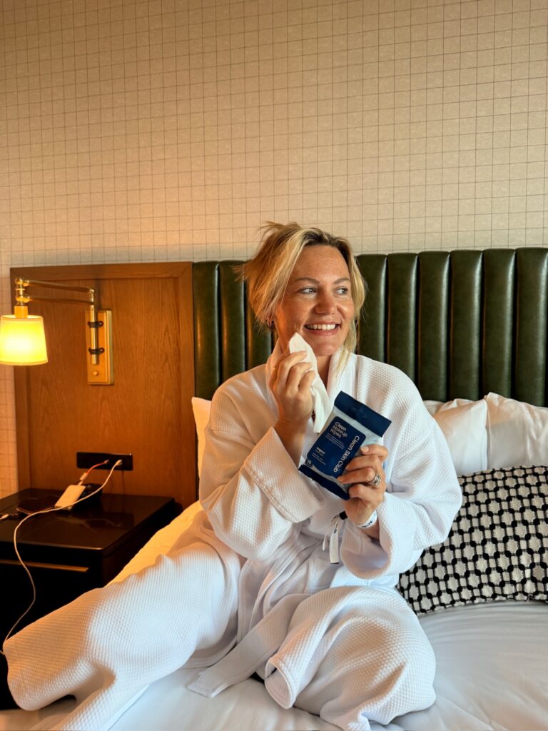 Audrie Dollins using Clean Skin Club Clean Makeup Wipes and Clean Towels Travel Packs during LTKCon 2026, featuring skincare essentials from a Parlay Collective influencer gifting partner.
